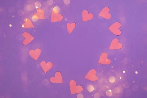 Herts with sequins on a violet background. Stock Photos