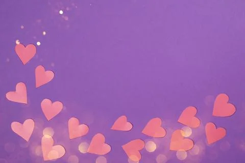 Herts with sequins on a violet background. Stock Photos