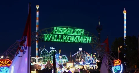 Herzlich Willkommen or Warm Welcome led sign at gate of amusement park. Stock Footage 113488032