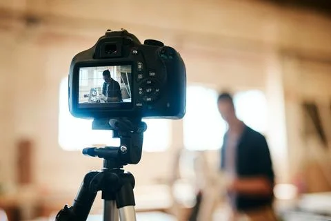 Hes all set to get the tutorial under way. Shot of young carpenter recording  Stock Photos