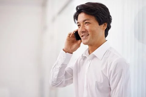 Hes always professional in his client communications. a handsome asian Stock Photos