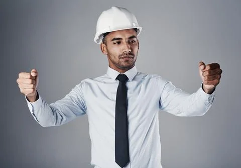 Hes committed his blueprints to memory. a well-dressed civil engineer pretending Stock Photos