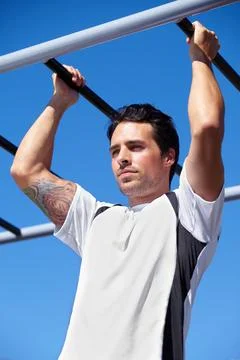 Hes constantly working to improve his fitness. A handsome young man working out Stock Photos