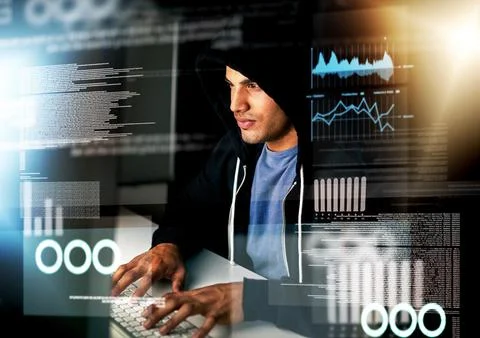 Hes an expert coder. a handsome young male computer programmer working on new Stockfoto's