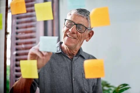 Hes the expert at formulating top ideas. a senior businessman brainstorming with Stock Photos