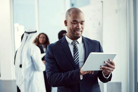 Hes found an efficient way to work. a handsome young businessman working on a Stock Photos