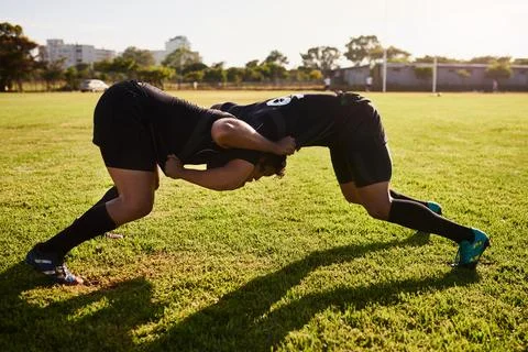 Hes going to win. Full length shot of two unrecognizable sportsmen tacking each Stock Photos