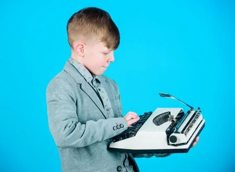 Hes going to write a composition. Smart child writer. Little writer typing on Stock Photos
