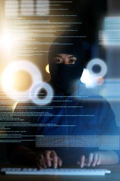 Hes got access to it all. Shot of a hacker cracking a computer code in the da 写真素材