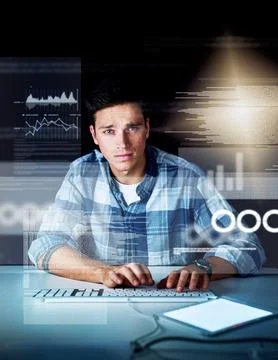 Hes got a keen eye for coding. a handsome young male programmer at work. Stock Photos
