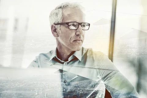Hes got plans for this city. Multiple exposure shot of a mature businessman Stock Photos