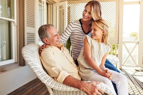 Hes got years of knowledge to pass on. a young girl sitting outside with her Stock Photos