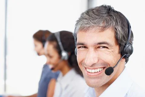 Hes here to answer all your questions. Closeup portrait of a call center Stock Photos