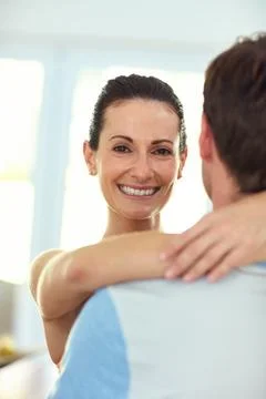 Hes my one and only. Portrait of a happy woman embracing her husband at home. Stock Photos