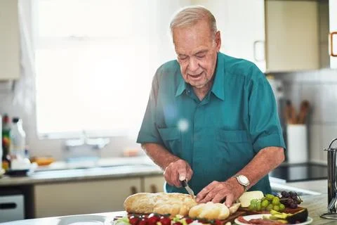 Hes still capable of making his own food. Cropped shot of a senior man making Stock Photos