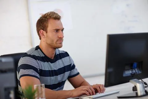 Hes a task-oriented individual. a young male designer working at his computer. Foto stock