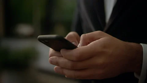 He’s texting Messages while standing near Modern Office Building. Wearing Video stock 131599303