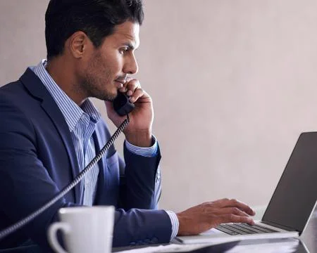 Hes working hard to complete his tasks. a handsome young businessman working at Foto stock