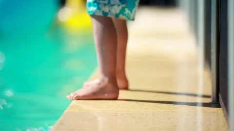Hesitant child jumps to the water Indecisive kid jumping inside pool Stock Footage