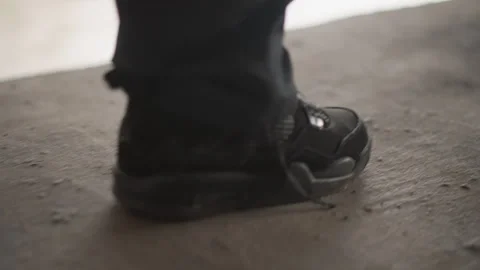 Hesitant step on moist concrete with gentle splash and reflection. Contemplative Stock Footage 346451475