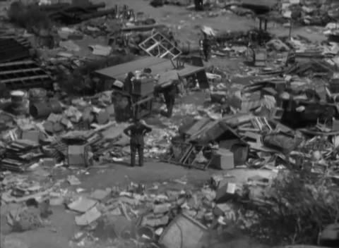 HESSE, GERMANY - 1946: Dump salvage - People pick through boxes on the refuse Stock-Footage 344485977