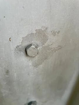 Hex bolt embedded in surface Stock Photos