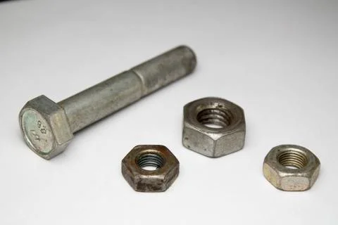 Hex nuts and bolt on white background Stock Photos
