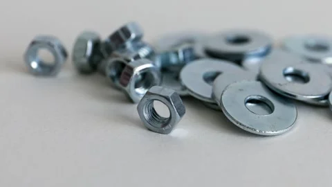 Hex Nuts and Flat Washers on White Background Close Up Hardware Set Stock Footage 333773823