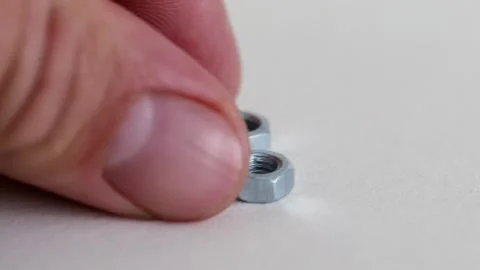 Hex Nuts on White Background Close Up Industrial Fastening Hardware Stock Footage 333773669