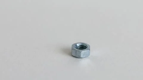 Hex Nuts on White Background Close Up Industrial Fastening Components Stock Footage 333773720