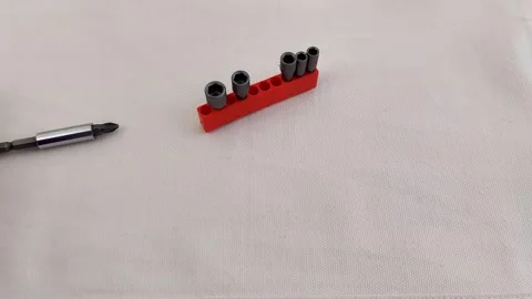 Hex Socket Bit Set on White Fabric with Red Holder and Screwdriver Stock Footage 321449961