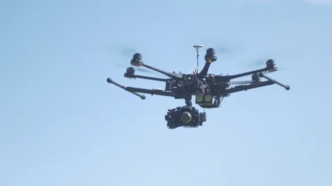 Hexacopter drone flying left to right. 4K Stock Footage 86664282