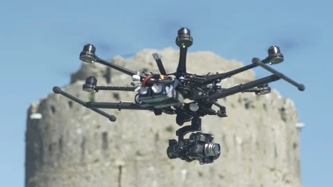 Hexacopter drone flying past ancient ruins. 4K Stock Footage 86664996
