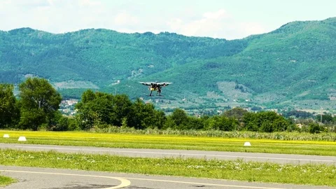 Hexacopter hovering over the airfield, slow motion HD Vídeo Stock 75462375