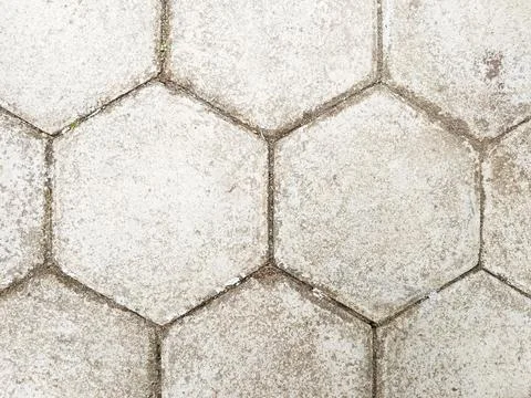 Hexagon block paving with worn, dusty surface and defined grout lines Stock Photos