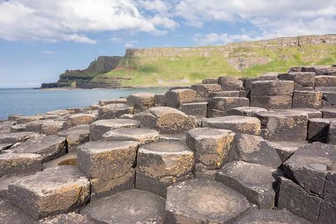 Hexagonal basalt columns at Giants Causeway Northern Ireland with sunburst .. Stock Photos