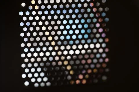 Hexagonal Bokeh Lights on Dark Background Stock Photos