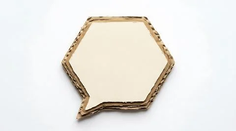 Hexagonal cardboard speech bubble cutout isolated on a clean white background Stock Photos