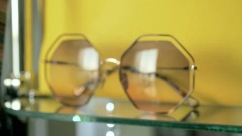 Hexagonal frame of a pair of glasses displayed in an optical shop Stock Footage 201539686