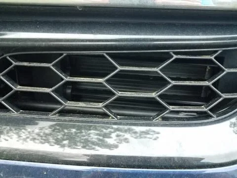 Hexagonal grill on front of car or automobile Stock Photos