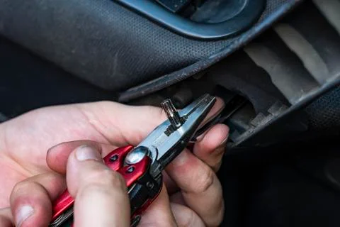 Hexagonal key in the mechanic's hand. Combination pliers. Stock Photos