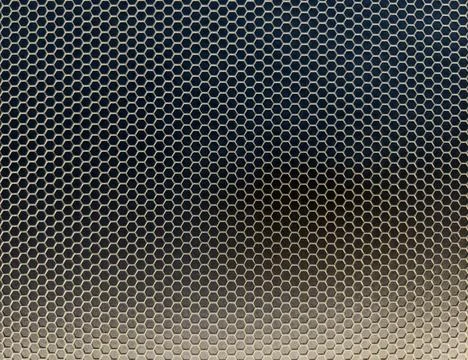 Hexagonal metal mesh pattern with dark gradient background Stock Photos