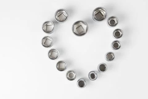 Hexagonal nests of different sizes in the shape of a heart on a white surface Stock Photos