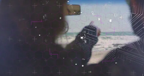 Hexagonal pattern and circuit animation overlaying person using computer in 스톡 동영상 304860807