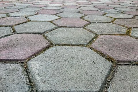 Hexagonal pavement blocks form a neat pattern with subtle shades of gray an.. Stock Photos