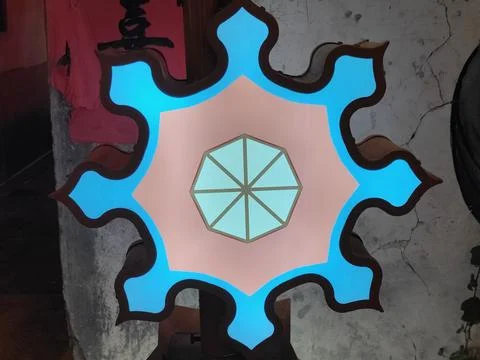 A hexagonal shape in the center of an oriental-style wall features pink and.. Stock Photos