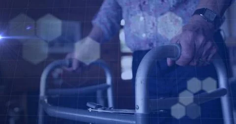 Hexagonal shapes over grid network against mid section of senior person using Stock Photos