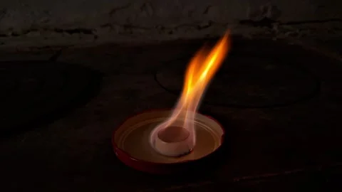 Hexamine solid fuel tablet burning with bright orange flame in the dark Stock Footage 331052853