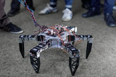 Hexapod robot prototype on classroom floor during STEM robotics workshop 스톡 사진