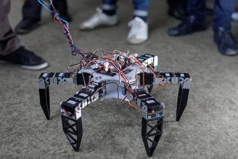 Hexapod robot prototype on classroom floor during STEM robotics workshop 스톡 사진